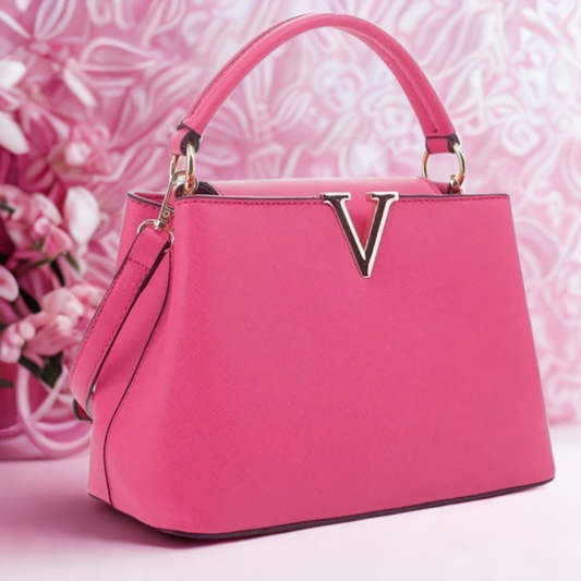 Pink handbag with a brand logo on a pink floral background