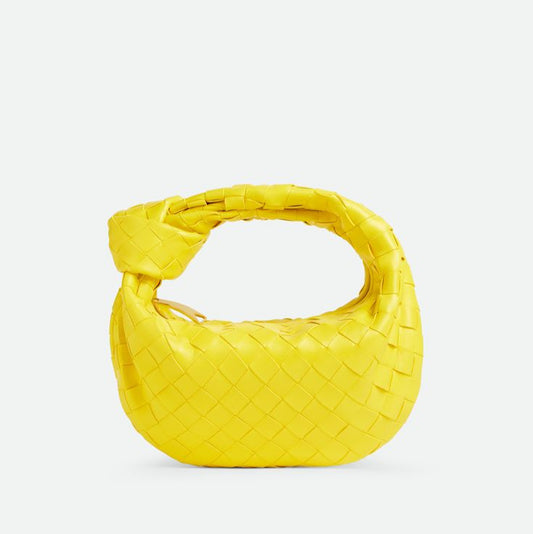 Yellow woven handbag on a light gray background